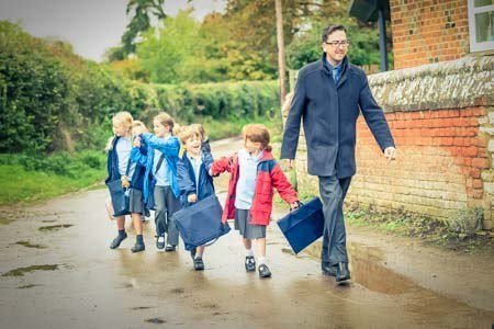 school psychologist walking with young children at school