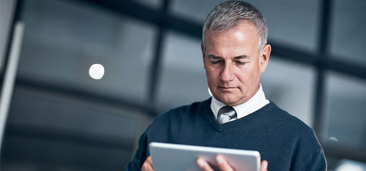 man looking at electronic notepad