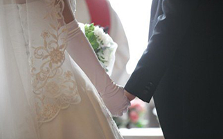 couple holding hands at wedding ceremony