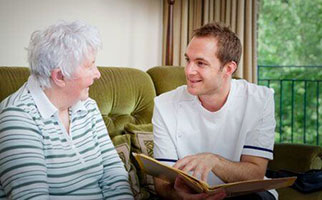 man talks with older person