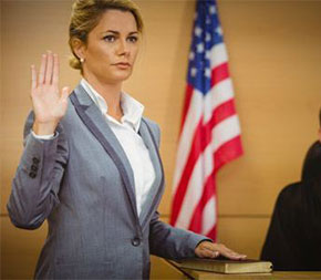 woman taking oath in courtroom