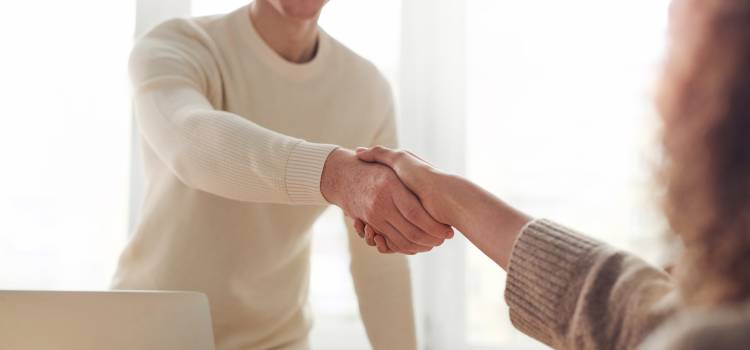 man and woman shaking hands after interview