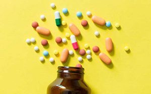 harmful drugs spilling out of brown glass bottle