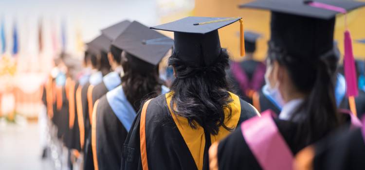 students in line to receive their bachelor's diploma