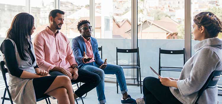 career counselor works with small group of people on job interview skills