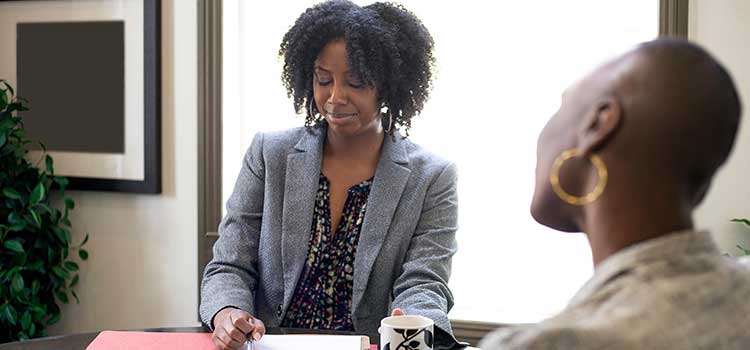 woman checks clients resume and job skills