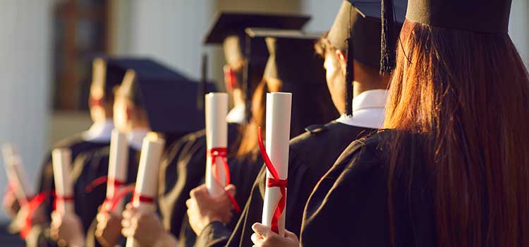 group of college graduates holding diplomas