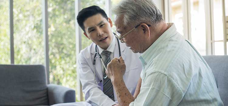 male psychologist comforts senior patient in distress