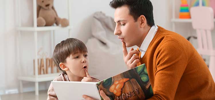 male therapist helps young student with sounds