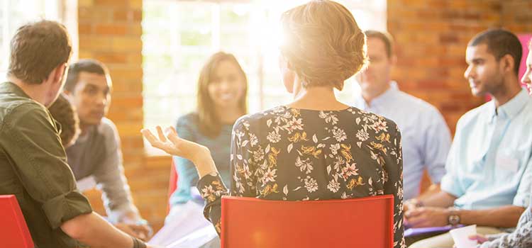counselor holds group session with diverse patients