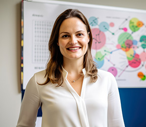 organizational psychologist stands in front of organizational charts and white board