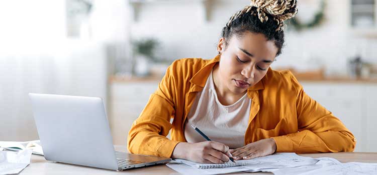 college student studying for class and taking notes