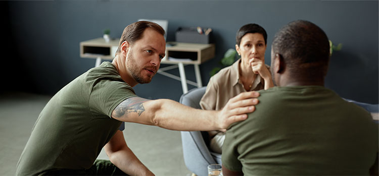 addiction counselor reaches out to distraught group member