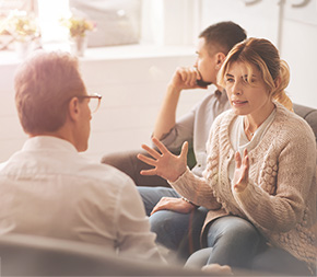 couple in marriage and family therapists office disagreeing on an issue