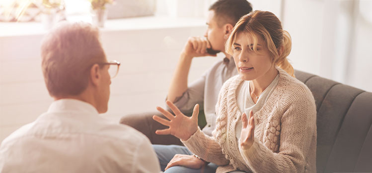 couple in marriage and family therapists office disagreeing on an issue