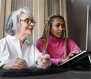 human services case manager helps elderly woman find resources online