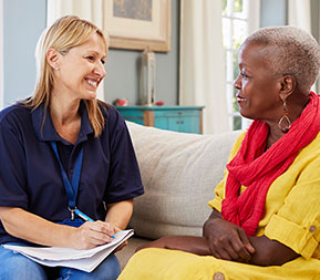 a social worker visits a client in their home and listens to their needs